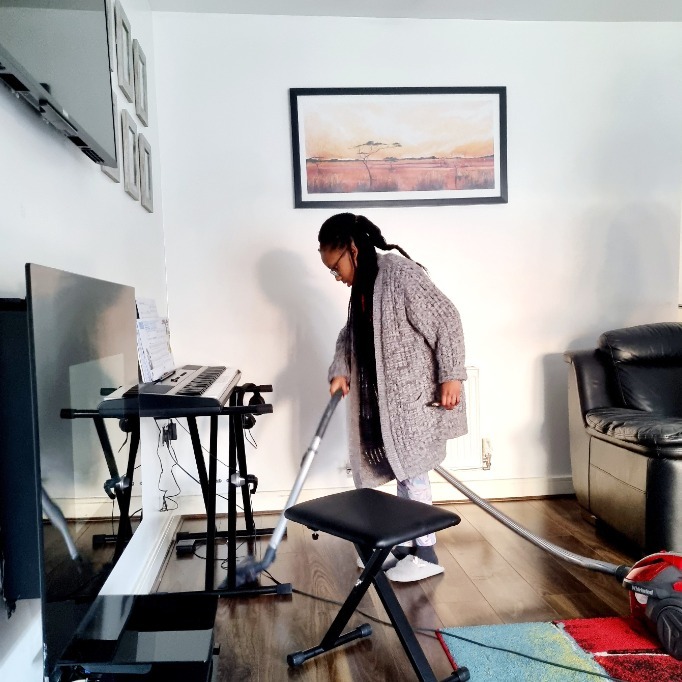 child hoovering the house