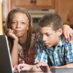 Woman and teenager looking at the computer