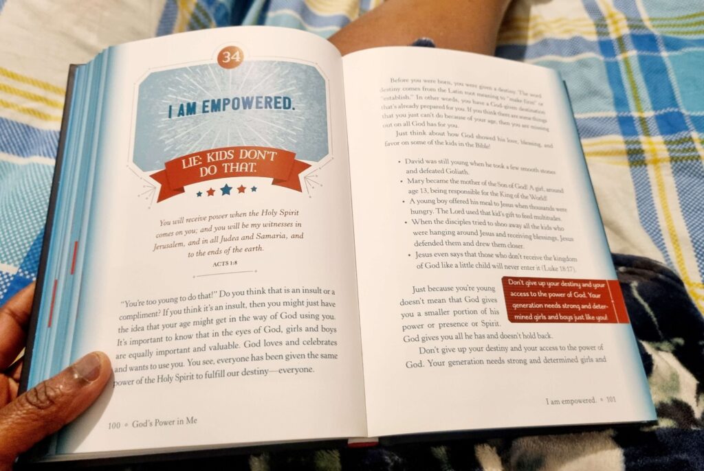 open devotional on someone's legs